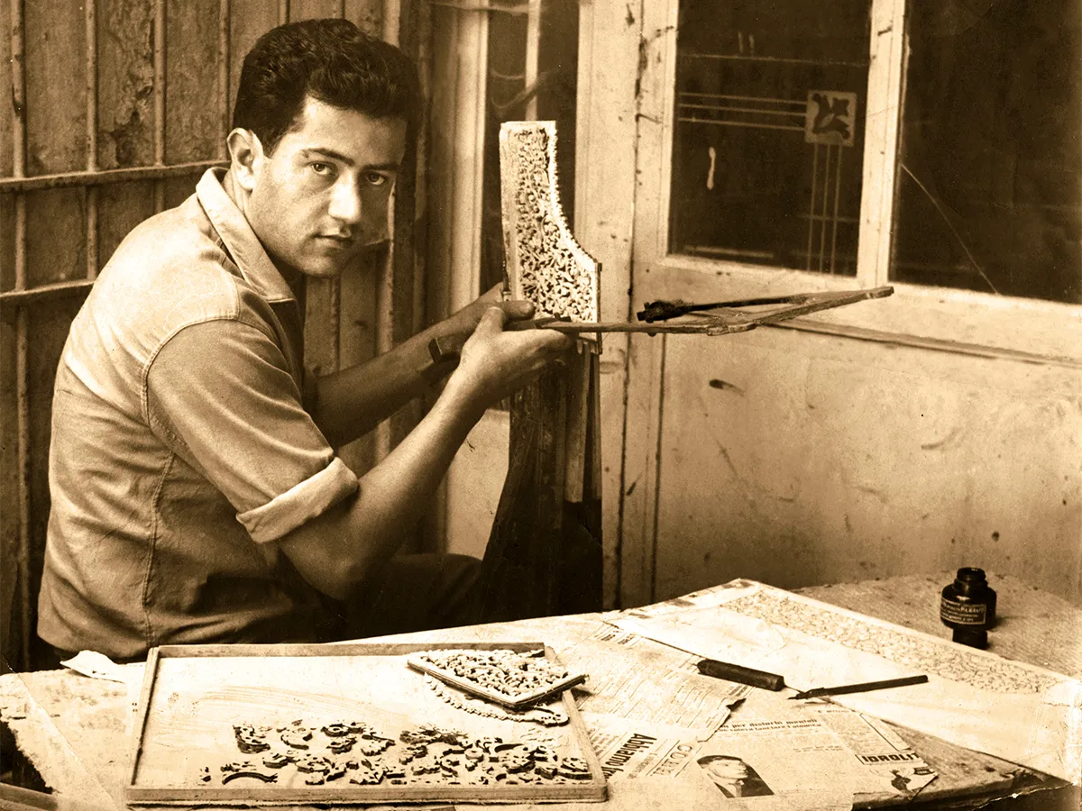 Giuseppe Ercolano cutting marquetry by hand at his bench in the Sorrento workshop, mid-20th century