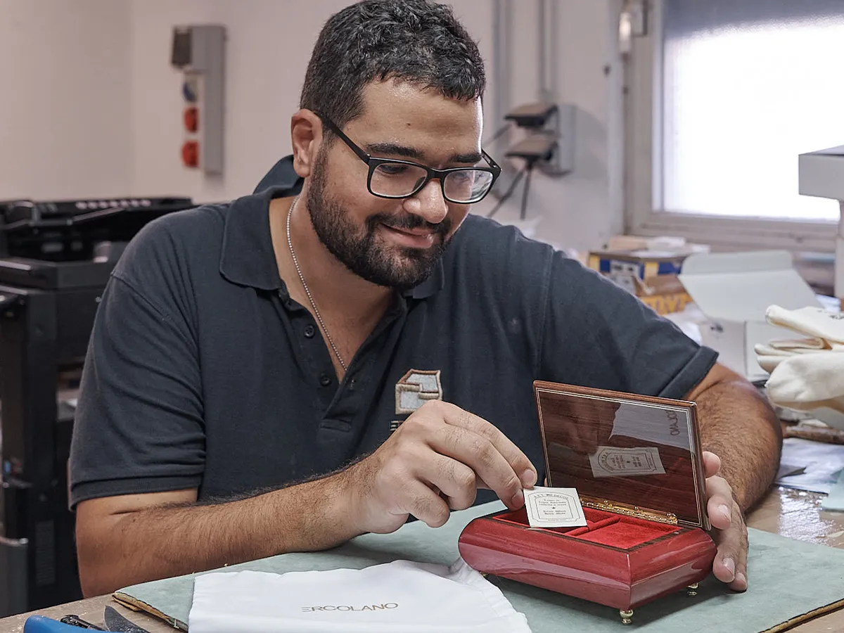 Craftsman finishing an Ercolano music box by hand in the Sorrento workshop