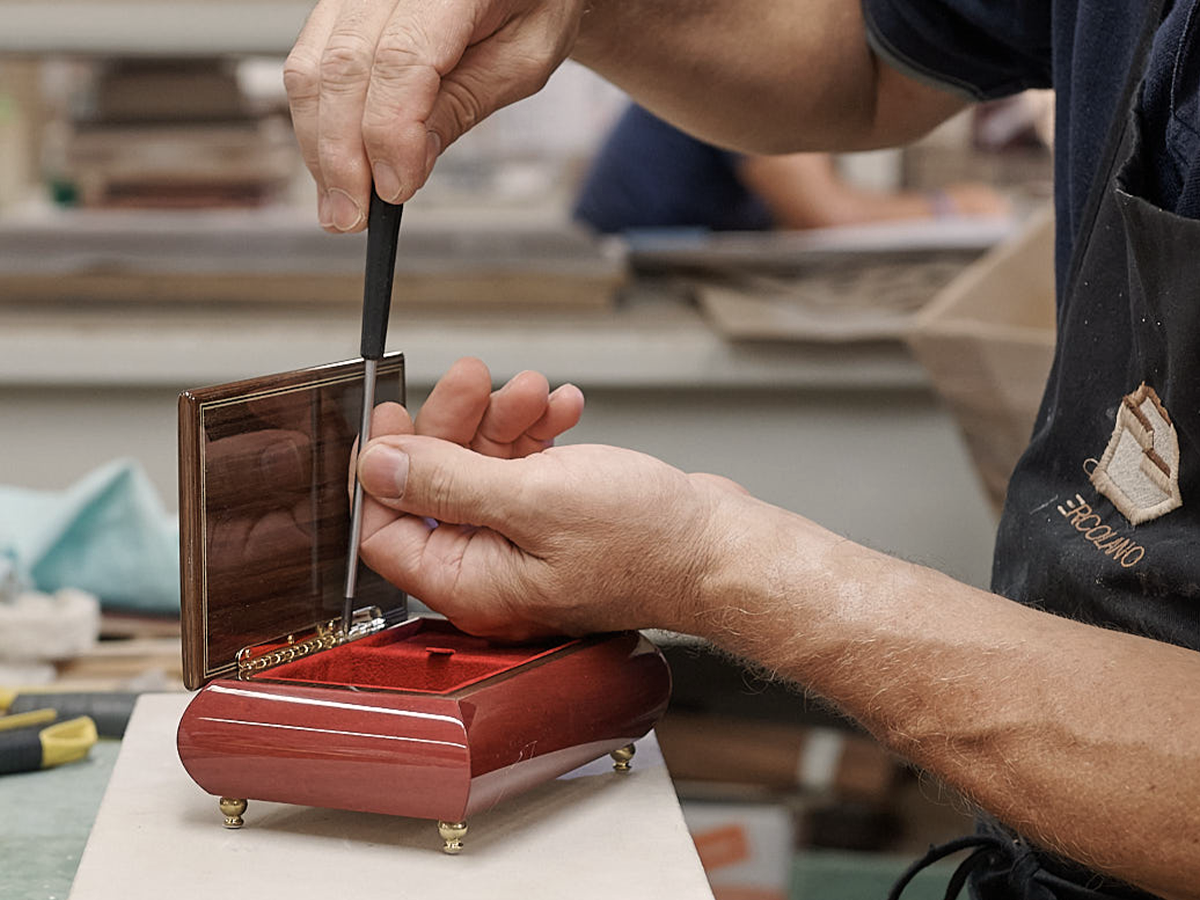 Artisan hand-finishing a Sorrento music box lid in the Ercolano workshop